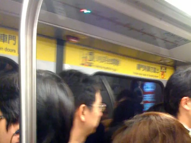 In this picture we can see a group of people inside of a vehicle.