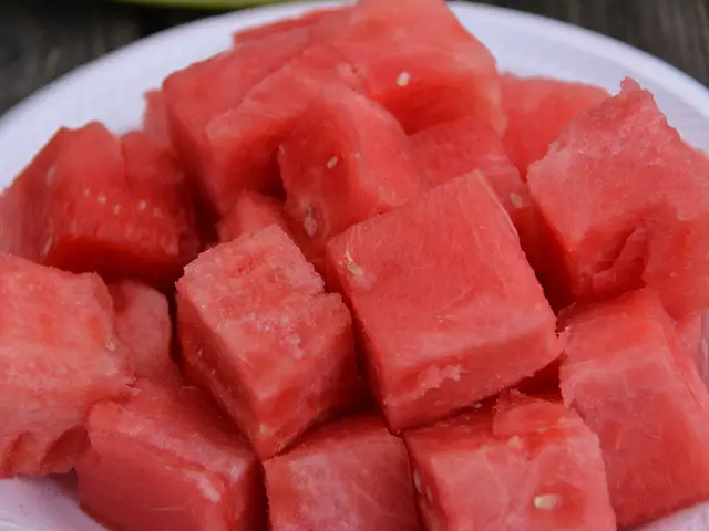 We can see water melon slices in a plate on a platform.