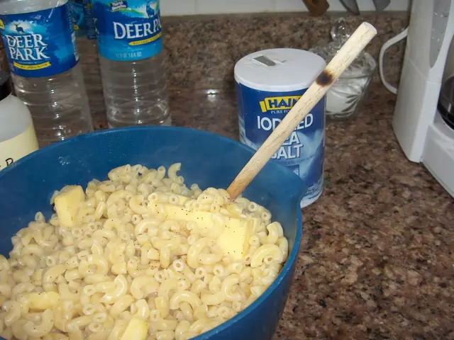 There is a food in the bowl on the table. There is a bottle and a tin here.