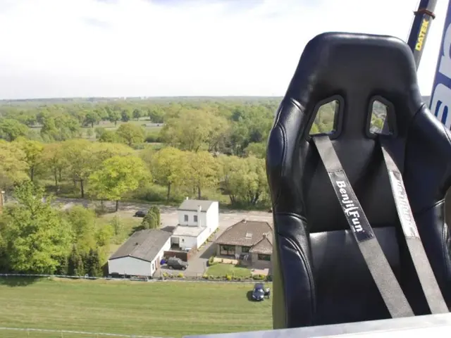 In this picture we can see black color leather seat seen in the image. Behind we can see many trees...